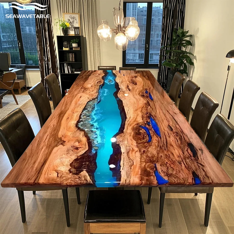Live edge epoxy resin river dining table with blue and turquoise tones, set in a modern dining room with black leather chairs.