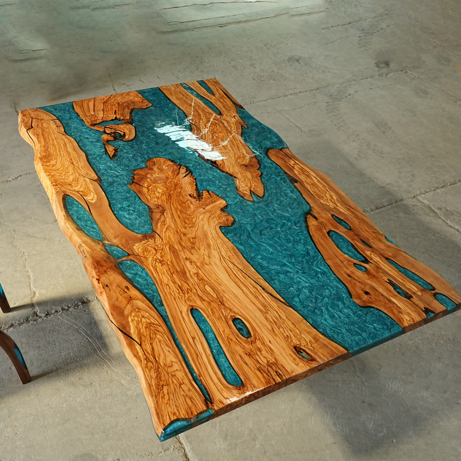 Custom live edge dining table made of olive wood and epoxy