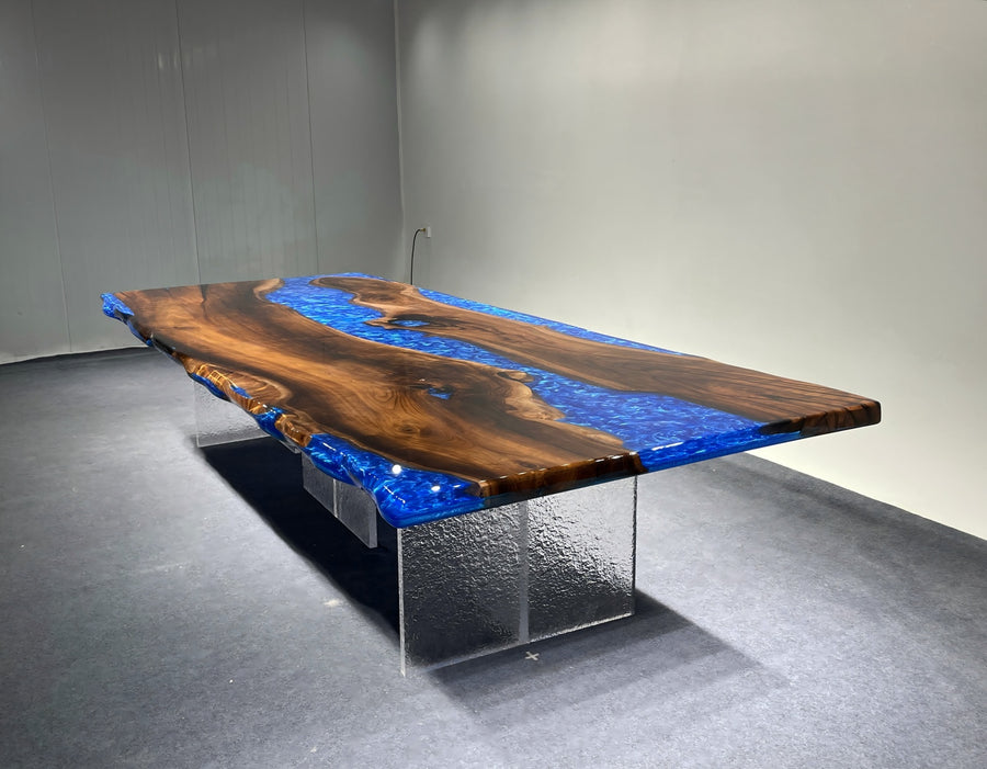 Wooden table with blue resin inlay on a gray floor