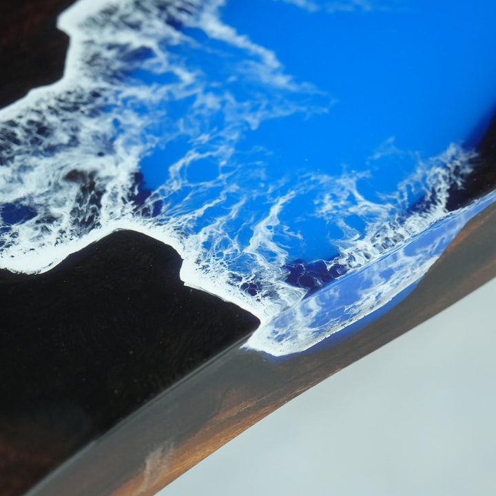 Large custom resin dining table with natural wood slabs and epoxy river