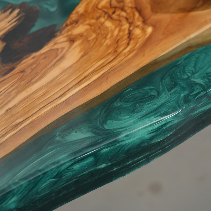 Custom epoxy river table with natural wood texture and ocean-inspired color