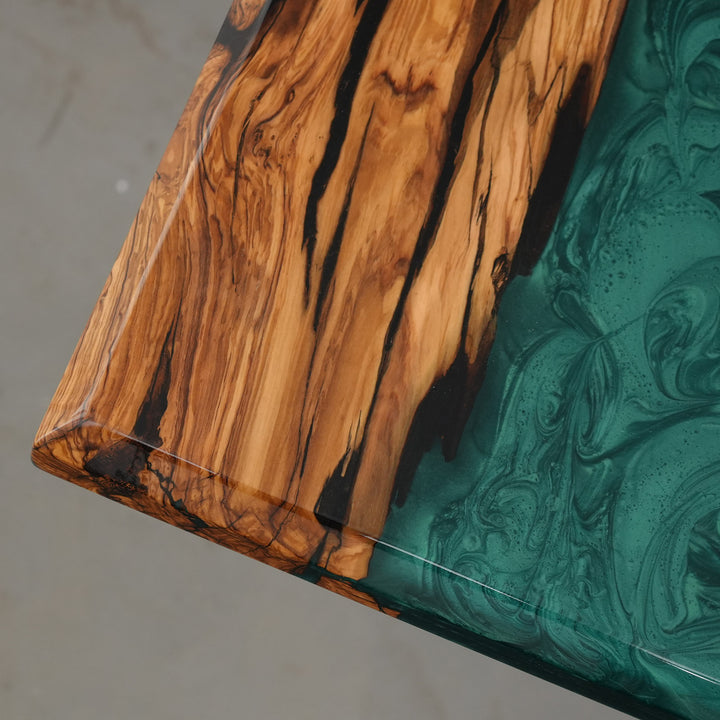 Unique live edge epoxy table with swirling emerald resin pattern