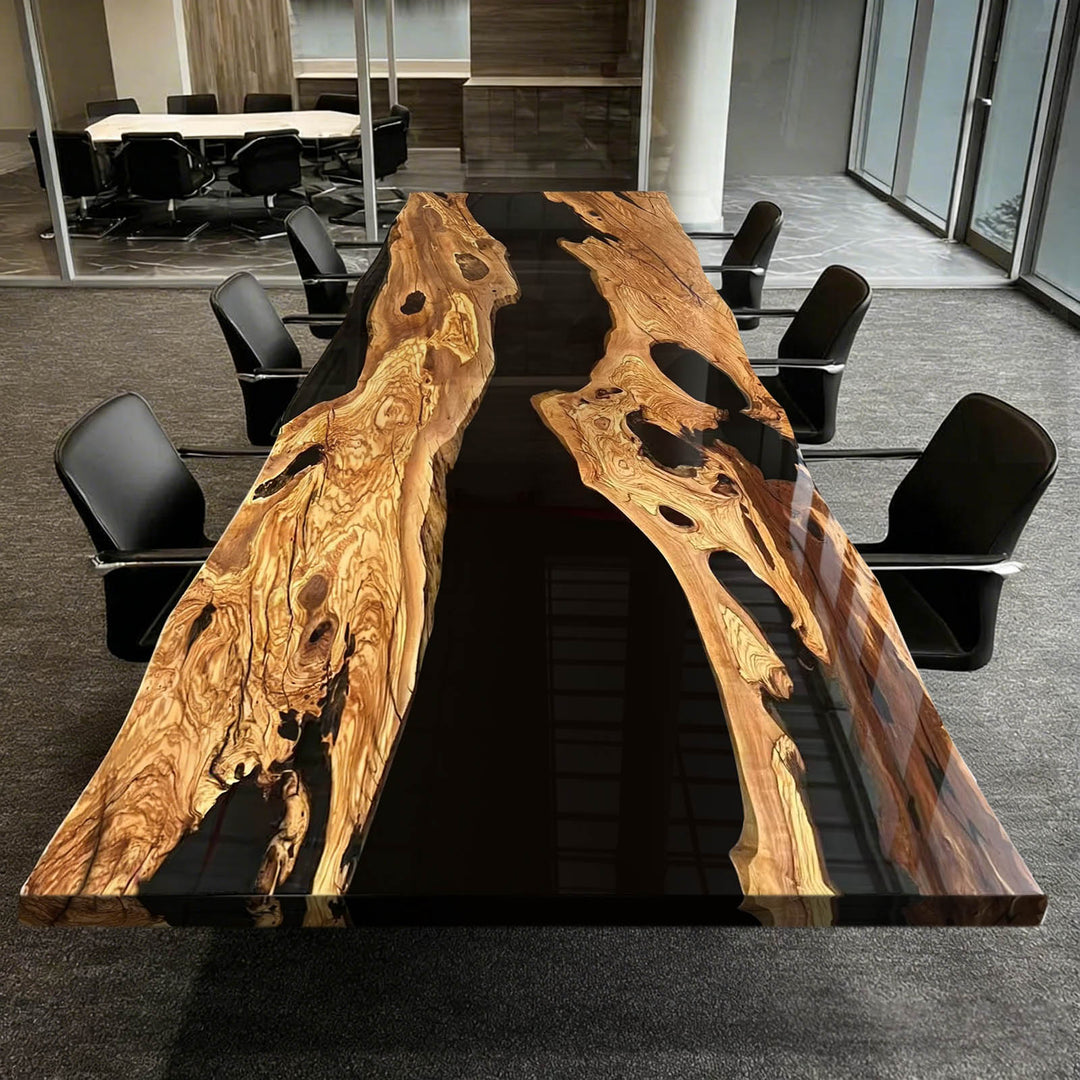 Wooden conference table with black resin inlay in a modern office setting