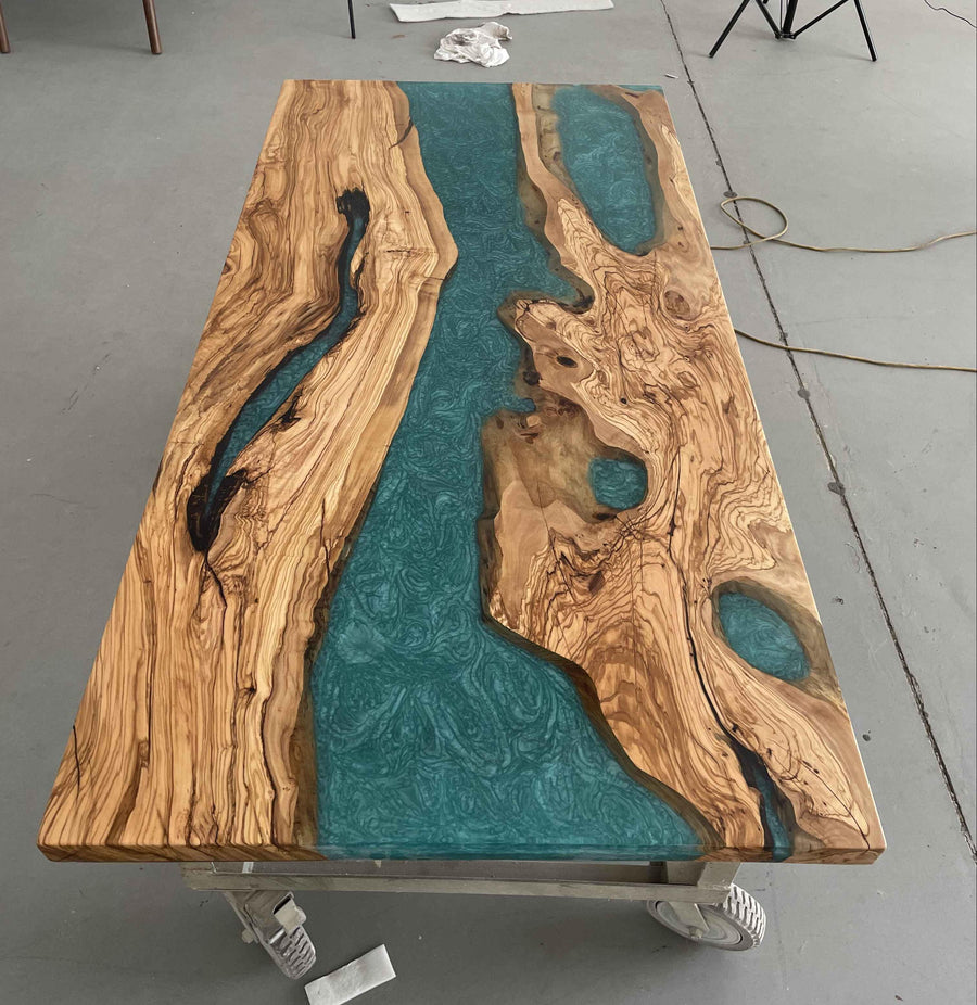 Unique dining table with natural live edge lumber and resin river