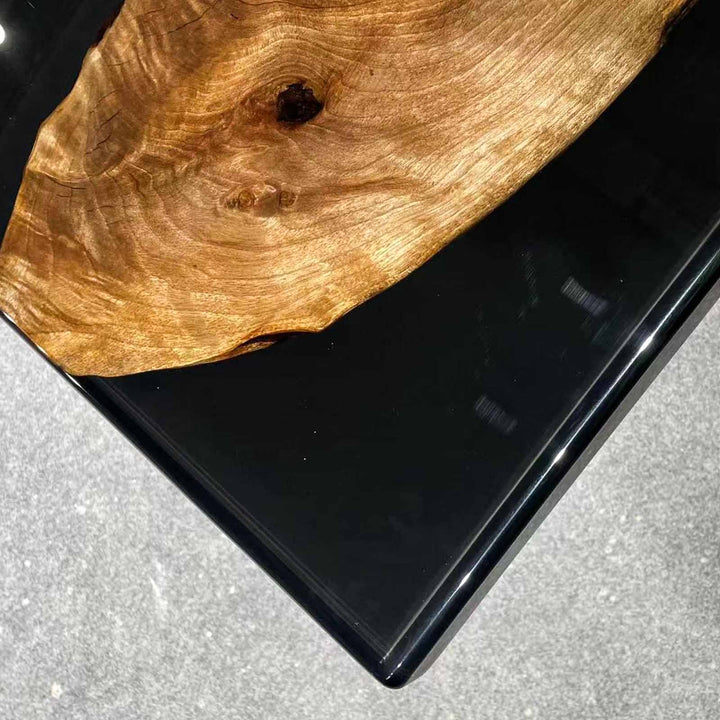 Mirror-like reflection on a midnight black epoxy resin art table surface