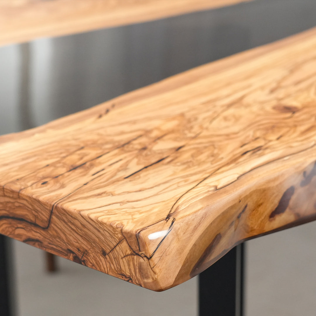 Luxury Colorado style dining table with black resin flow and natural wood texture.