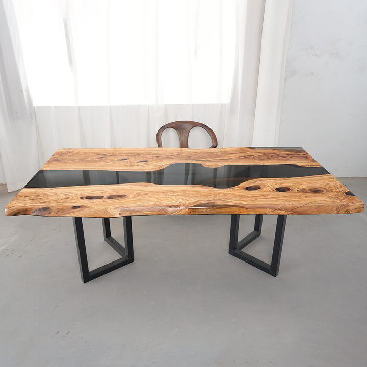 Handcrafted Black Onyx resin river table for mountain retreat interior design.