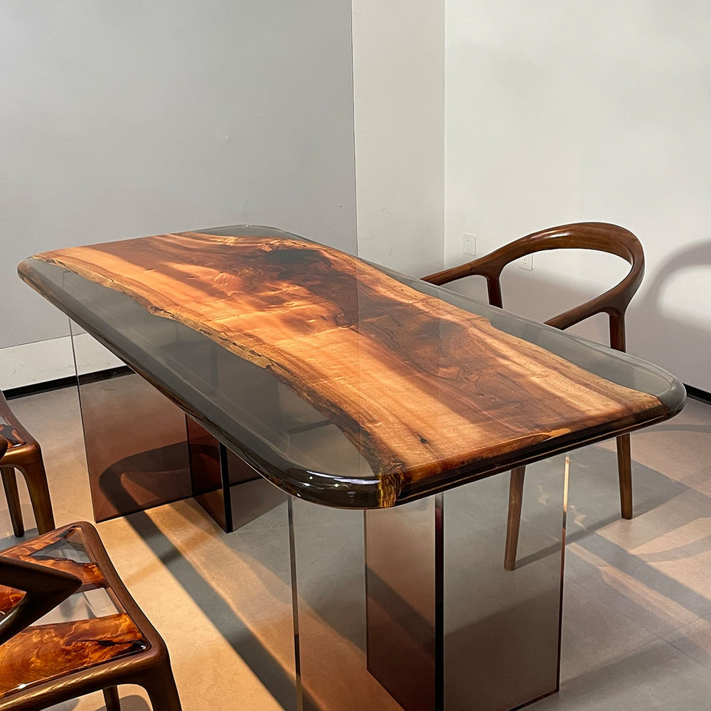 A resin - encased wooden table with a smooth surface, accompanied by wooden chairs.