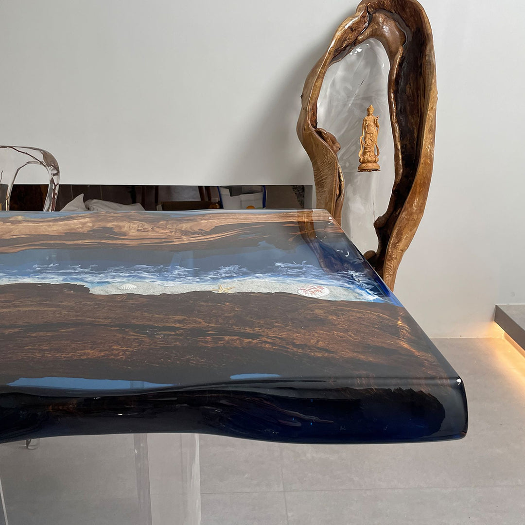 A close - up of a resin table with a scenic ocean - like design and smooth glossy surface.
