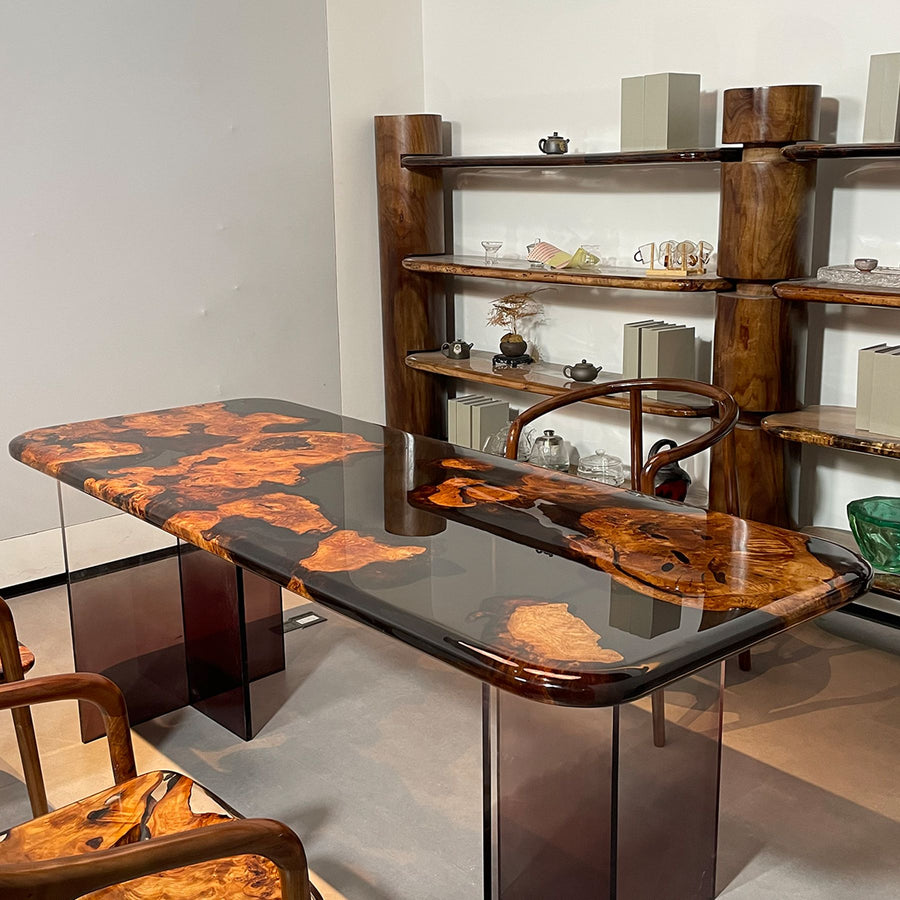 A 78.74''×31.5''×2.17'' golden camphor wood resin table with a unique design, accompanied by matching chairs.