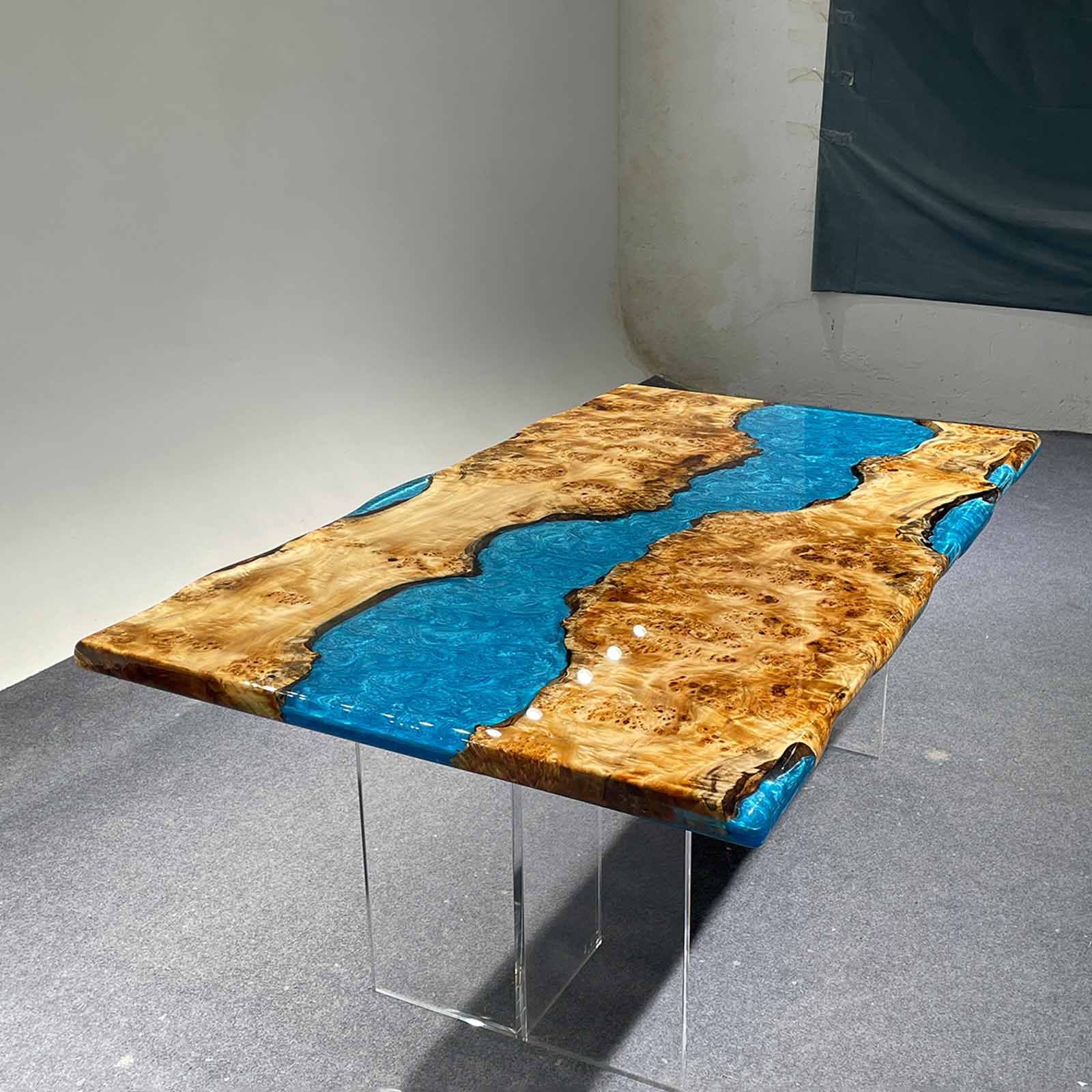 Table leg craftsmanship detail paired with blue resin tabletop