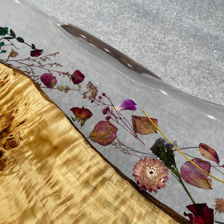 Modern coastal-style epoxy dining table with botanical inclusions