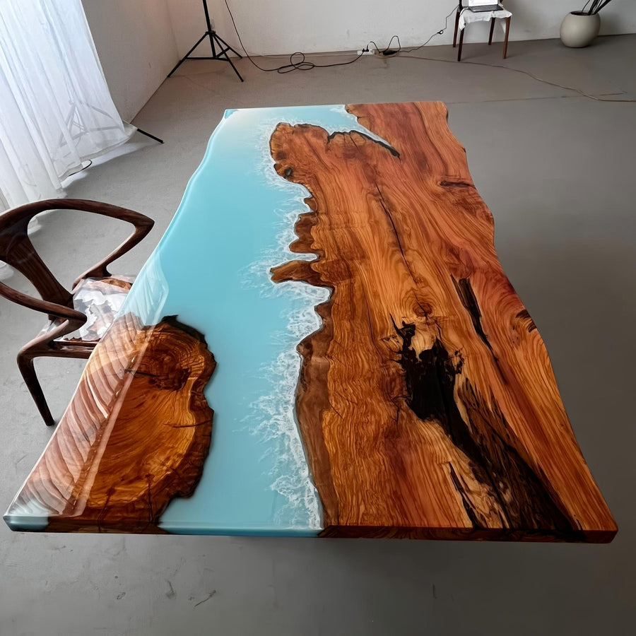 Glossy olive wood epoxy table with sky blue resin river and wave detail, 42x84x2 inches