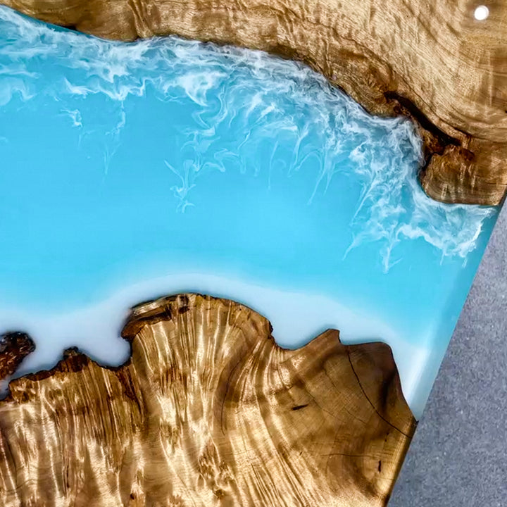 Luxury coffee table with golden camphor wood and transparent ocean epoxy