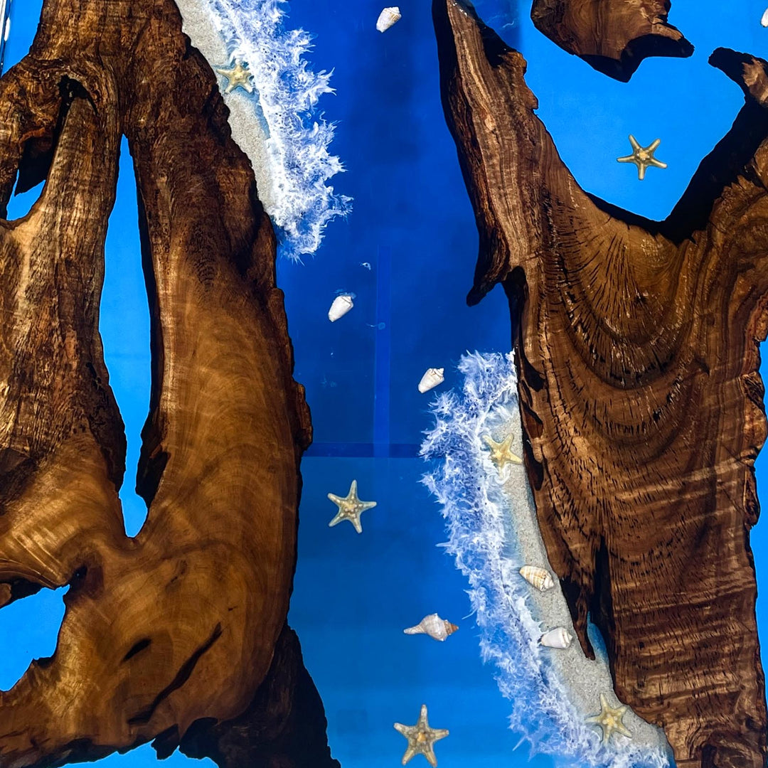 Blue resin wood table with embedded shells and starfish accents