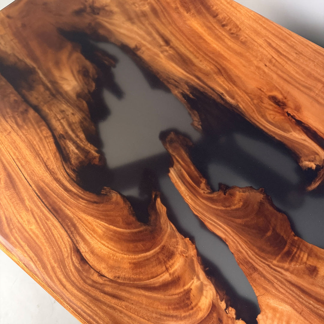 Close-up of walnut wood grain and high-gloss epoxy finish.