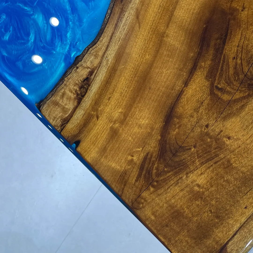 Blue river dining table showcasing rich wood grain and glossy resin