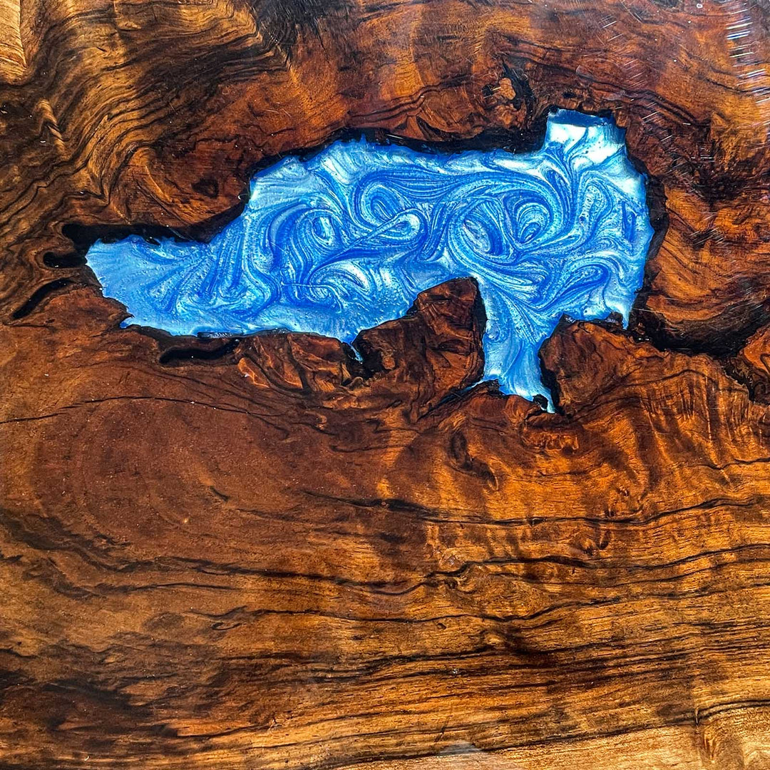 Statement oval table with dramatic blue epoxy and black walnut