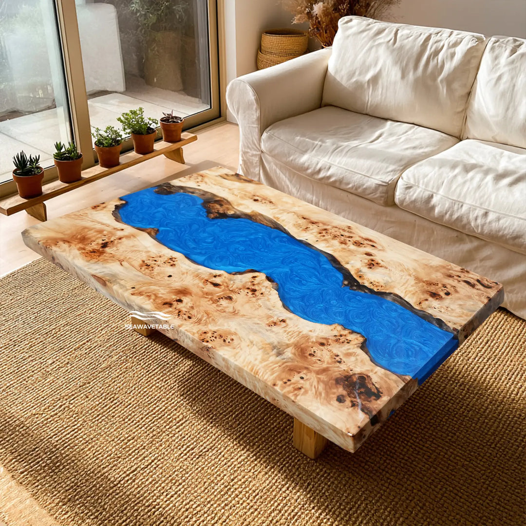 Blue epoxy river dining table featuring natural poplar wood grain and burl patterns