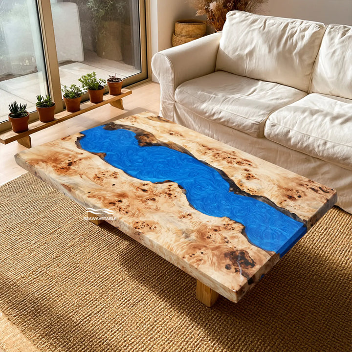 Blue epoxy river dining table featuring natural poplar wood grain and burl patterns