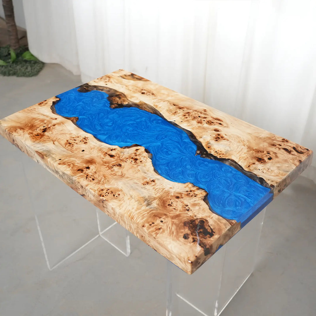 Natural poplar wood burl grain surrounding a vibrant blue epoxy river