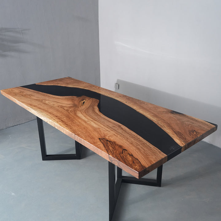 Custom epoxy river dining table with natural walnut grain and sleek minimalist base design