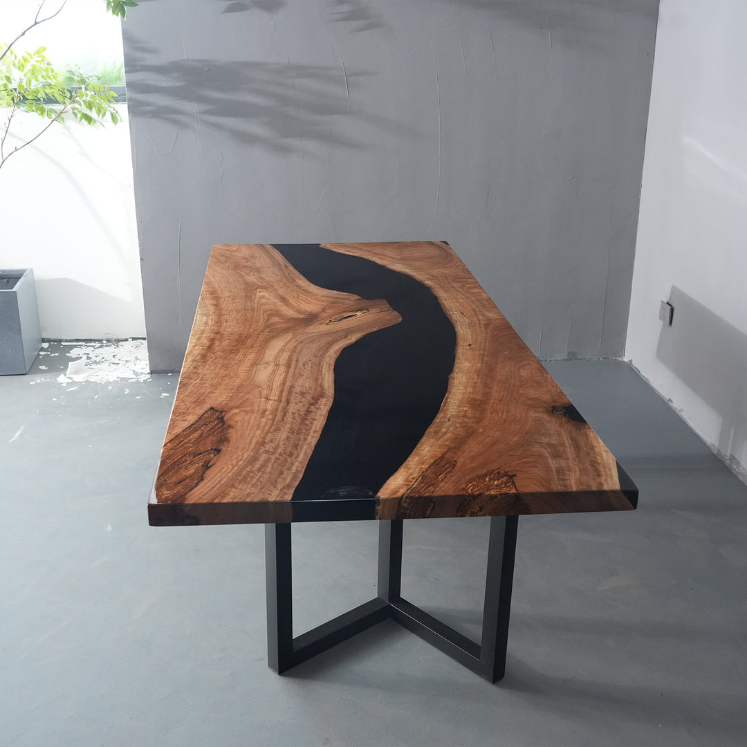 Solid wood straight edge dining table featuring deep black epoxy river centerpiece and modern aesthetic