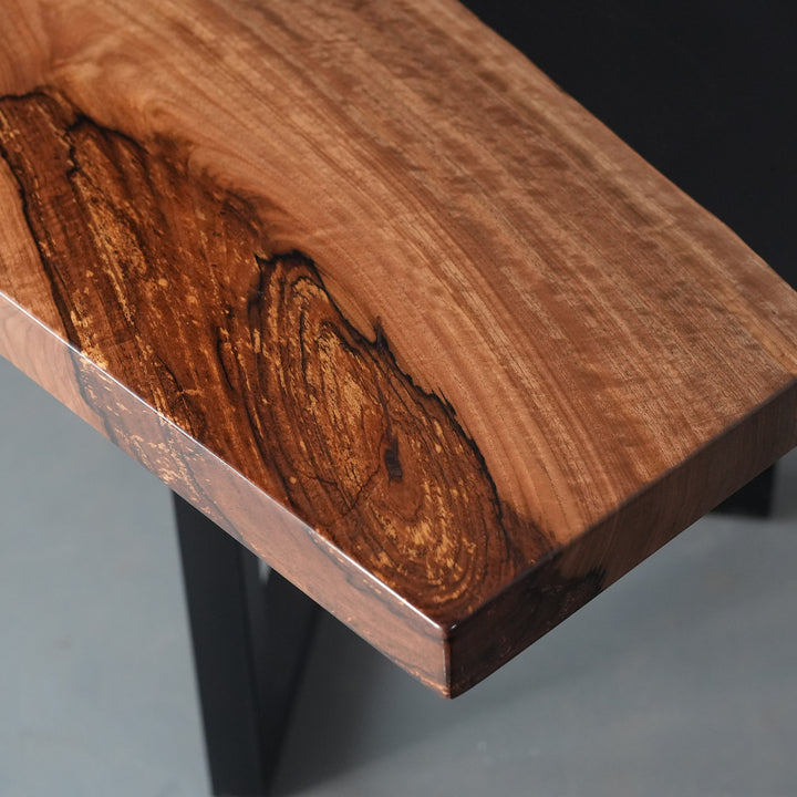 High-end balck walnut wood slab table with dramatic black epoxy inlay for luxury dining spaces