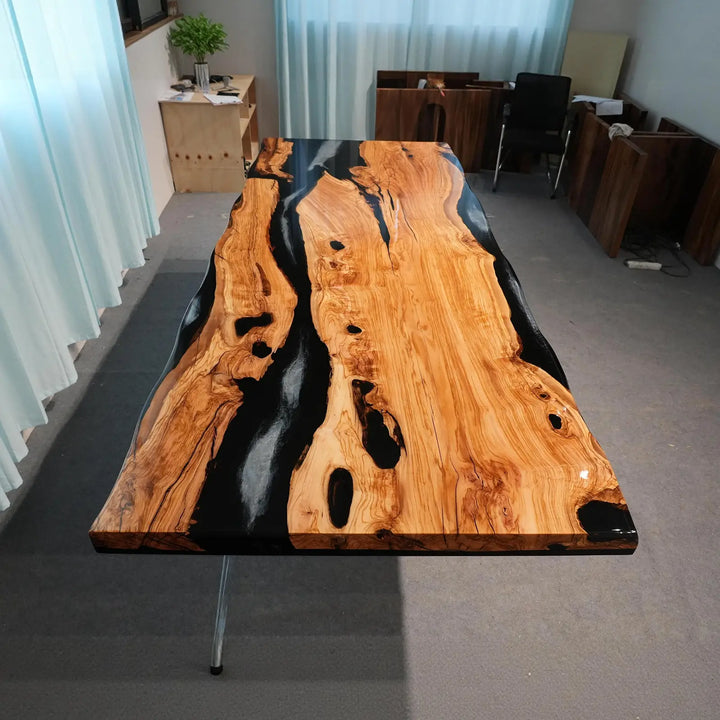 Golden olive wood tabletop featuring flowing black epoxy resin channels