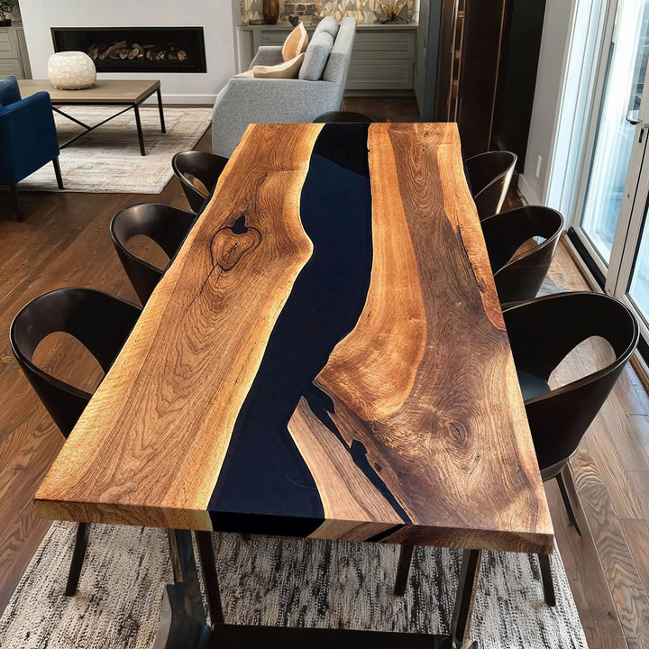 Straight edge walnut and black resin river table for modern dining room interior.