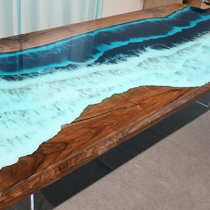 Luxury ocean wave resin dining table with natural black walnut wood grain and white surf details