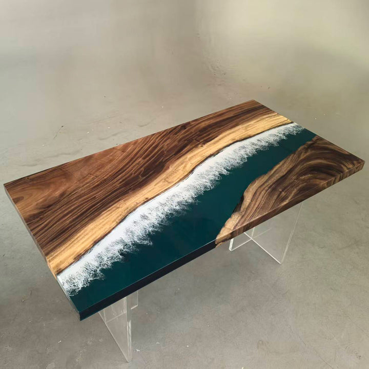 Top-down view of unique live edge walnut and deep teal resin river table with white wave effect.