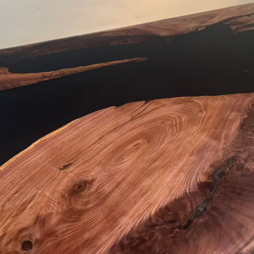 Unique irregular black resin distribution between two slabs of authentic black walnut.