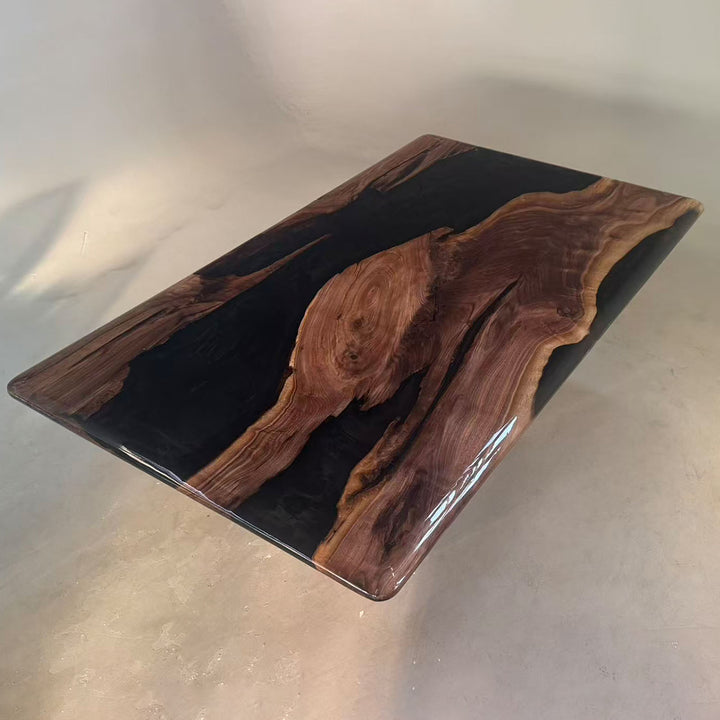 Top view of an 84-inch black walnut dining table with a glossy black epoxy river design.