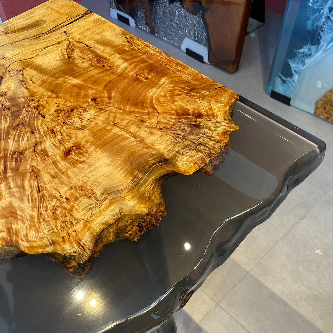 Close - up of a live - edge poplar wood resin table with intricate grain patterns