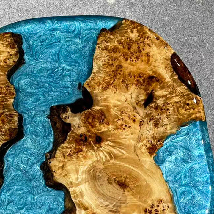 Blue resin and poplar wood coffee table in modern coastal interior setting.