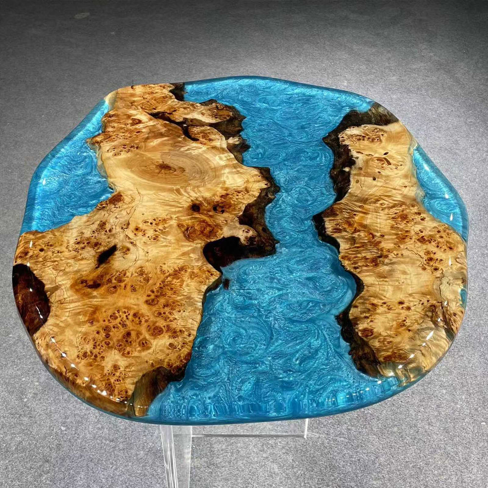 Organic-shaped poplar wood coffee table featuring bright blue ocean-inspired epoxy.