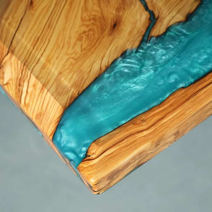 Contemporary dining table with ocean-inspired turquoise epoxy resin