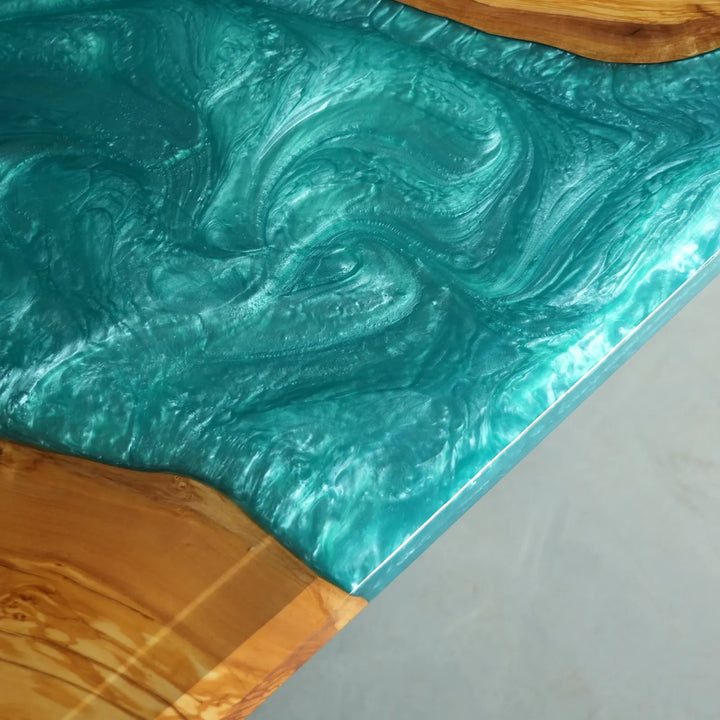 Artistic turquoise river epoxy dining table with flowing natural wood patterns