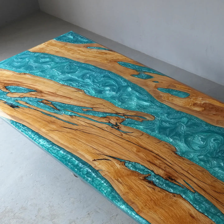 Turquoise blue epoxy resin flowing between natural wood sections on CRT-401