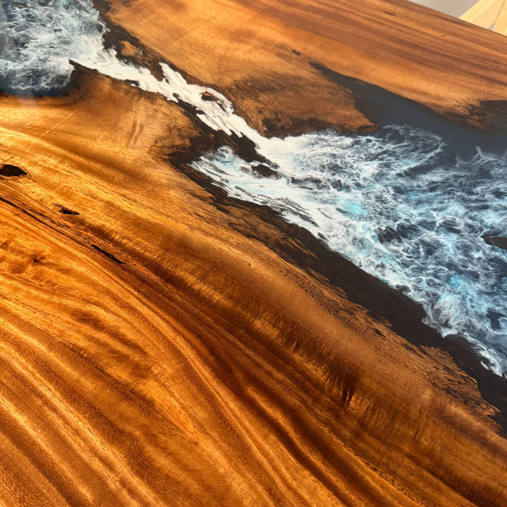 Close-up of 3D ocean wave effect in blue epoxy resin with white seafoam detailing.