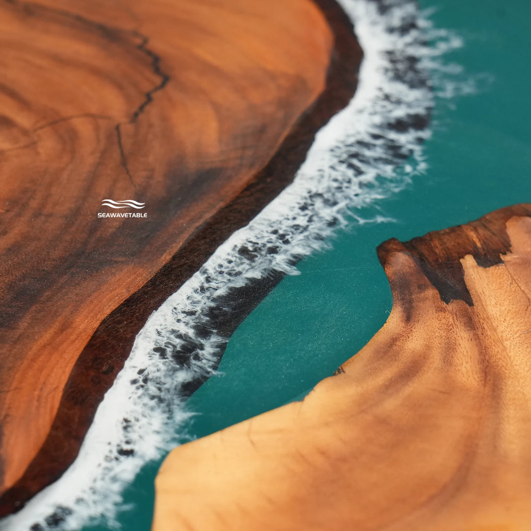 Close-up of teal epoxy resin and natural wood grain on a handcrafted ocean wave dining table