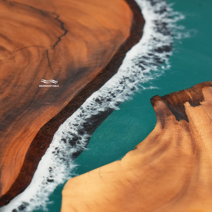 Close-up of teal epoxy resin and natural wood grain on a handcrafted ocean wave dining table