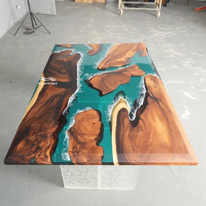 Modern coastal dining table with glossy teal epoxy resin and rich brown natural wood grain