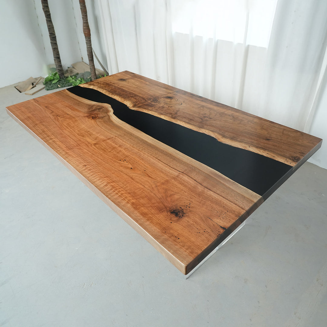 Handcrafted black walnut river table in warm rustic dining room
