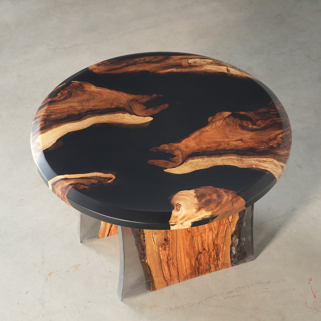 Round walnut and black epoxy resin coffee table in New York industrial style