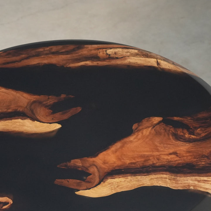 Industrial modern round coffee table featuring solid walnut and black resin