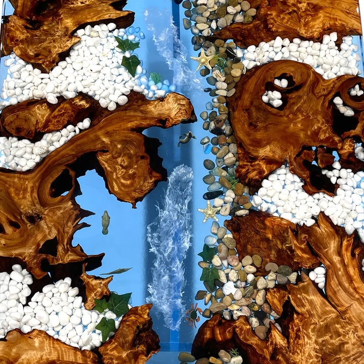 Modern coastal dining table with embedded rocks and clear epoxy finish