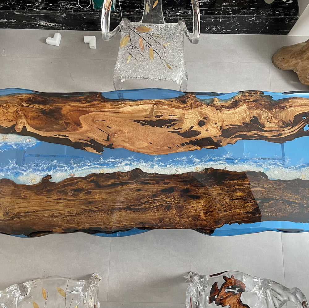A resin table with a striking ocean - inspired design, featuring natural wood grains and blue resin waves.