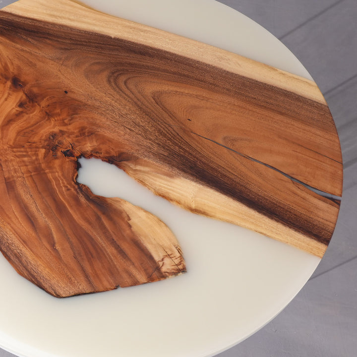 Coastal-style interior featuring round walnut epoxy coffee table